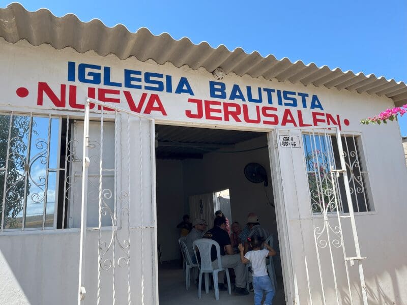 Small church entrance with people inside.