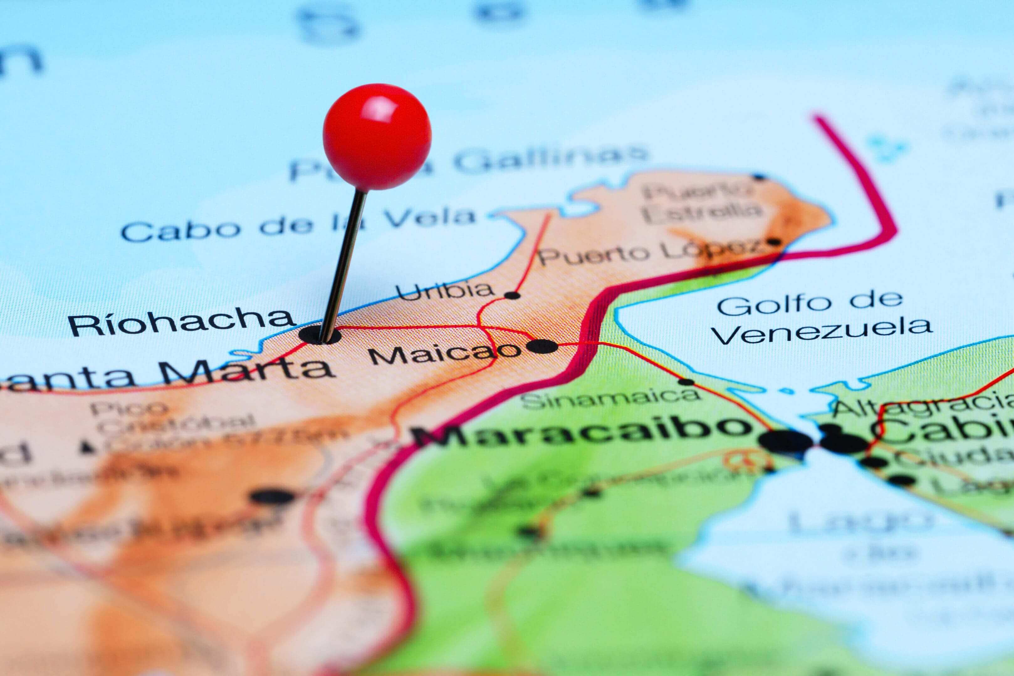 Close-up of a map with a red pin marking Santa Marta, Colombia.
