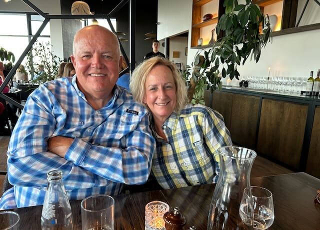 Smiling elderly couple enjoying time together at a cozy restaurant.