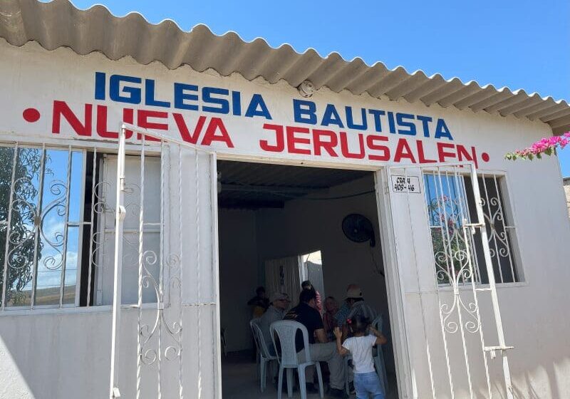 Small church entrance with people inside.